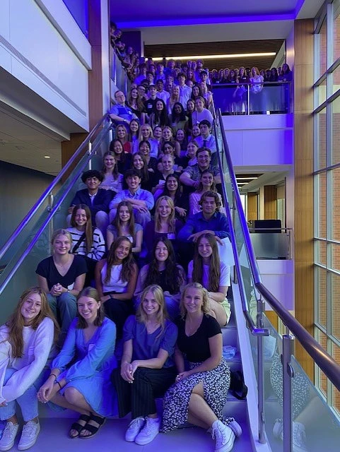  The newest cohort of Creighton Pre-Professional Scholars gathers for a picture under the blue lights at the Harper Center. About a hundred scholars joined us to launch our Fall semester programming